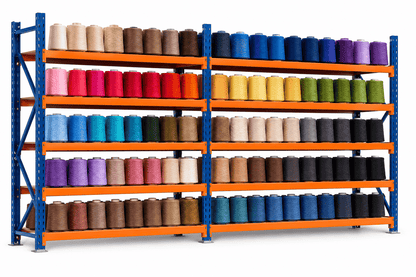 Blue and orange yarn storage racks holding color-sorted cones of yarn on five shelf levels