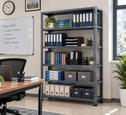 Gray office file rack holding binders, books, copy paper, and file boxes in an office with a desk and whiteboard.